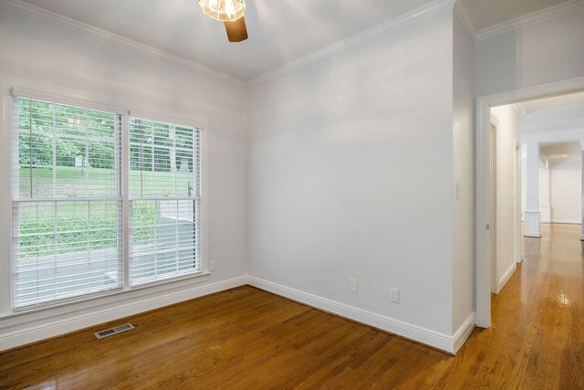 spare room with crown molding, ceiling fan, and wood-type flooring