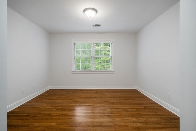 spare room featuring dark hardwood / wood-style flooring