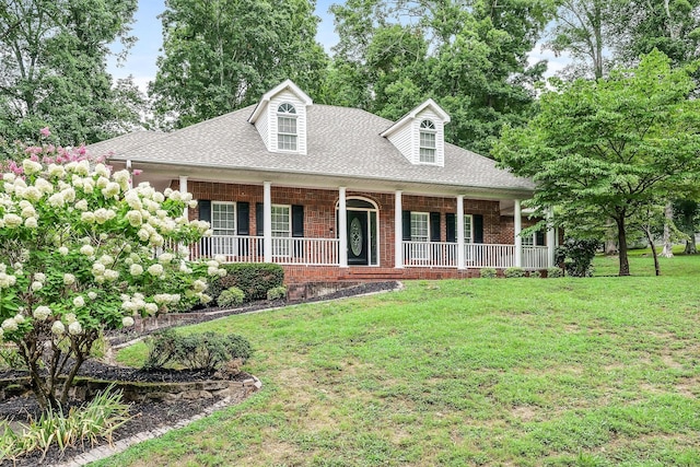 cape cod-style house with covered porch and a front yard