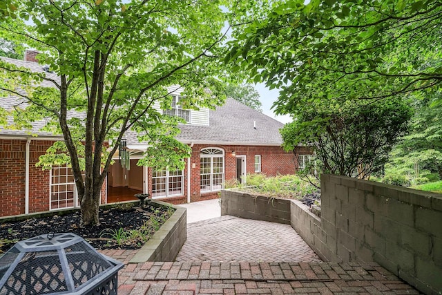 view of patio with central AC and a fire pit