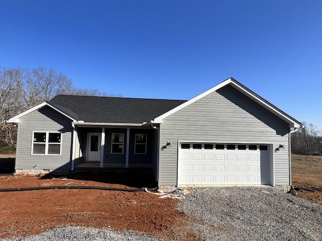 ranch-style home with a garage and covered porch