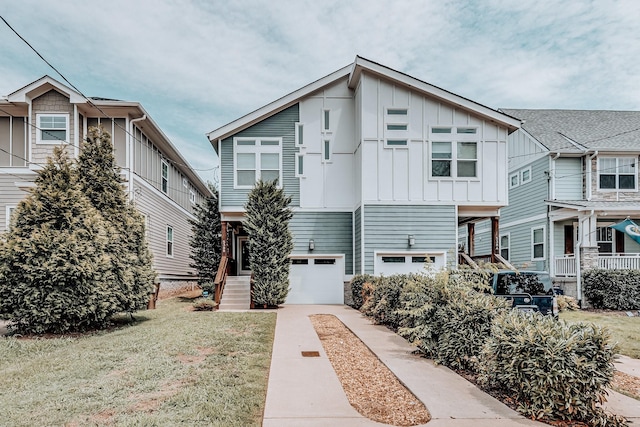 townhome / multi-family property with a front yard and a garage