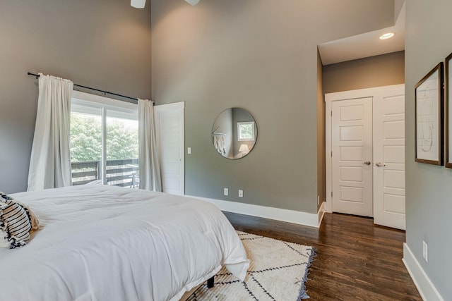 bedroom featuring ceiling fan, dark hardwood / wood-style flooring, and a closet