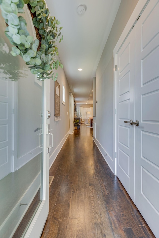 corridor with dark wood-type flooring