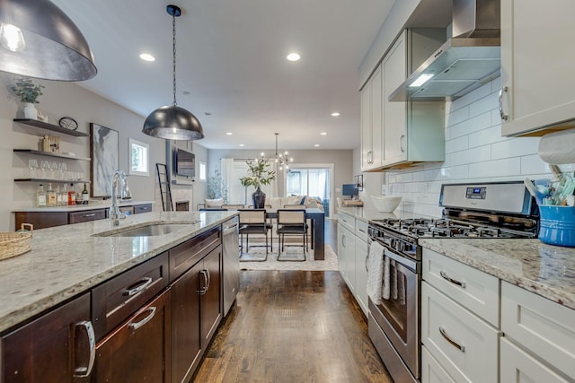 kitchen featuring white cabinets, sink, wall chimney exhaust hood, dark hardwood / wood-style floors, and appliances with stainless steel finishes