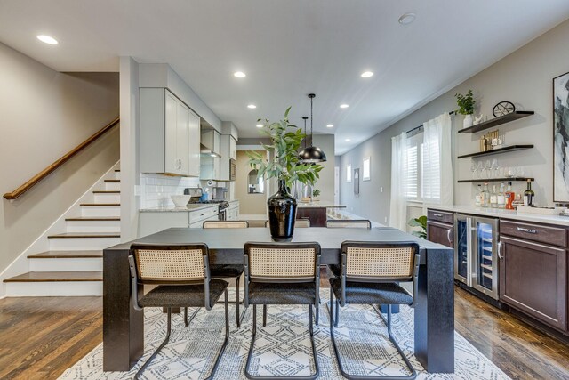 dining room with wine cooler, dark hardwood / wood-style flooring, and indoor bar