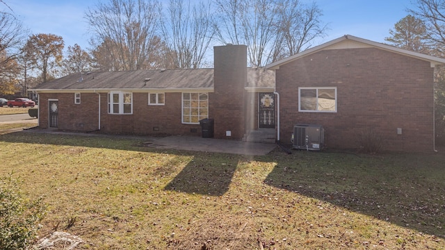 rear view of property with a patio area, a yard, and central air condition unit