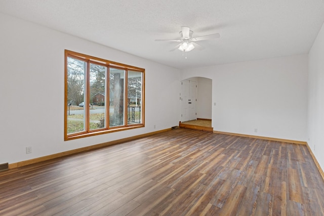 spare room with ceiling fan, dark hardwood / wood-style flooring, and a textured ceiling