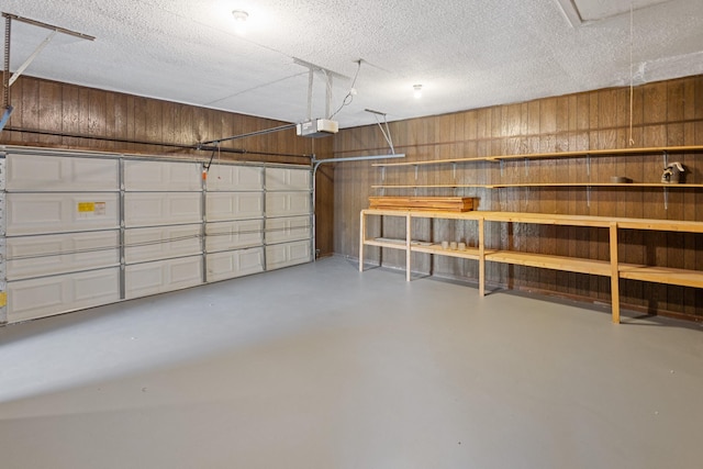 garage with wooden walls and a garage door opener