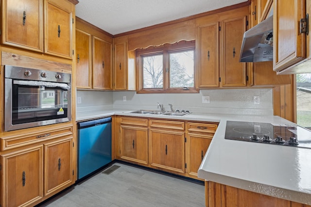 kitchen featuring a textured ceiling, sink, and stainless steel appliances