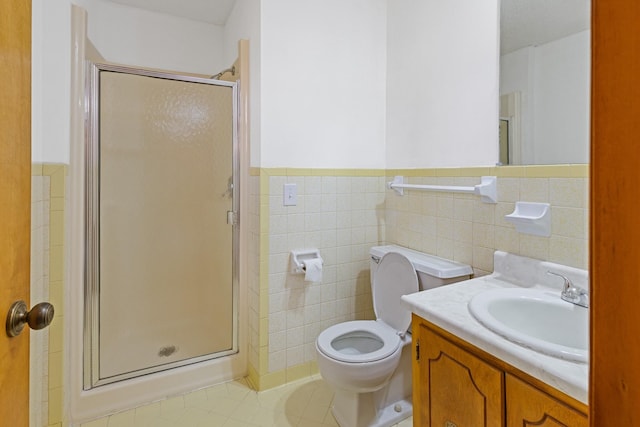 bathroom with a shower with door, tile patterned flooring, tile walls, and toilet