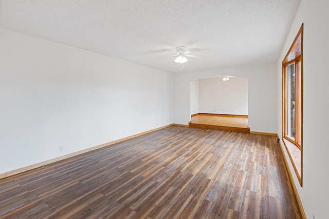 empty room with hardwood / wood-style floors, a textured ceiling, and ceiling fan