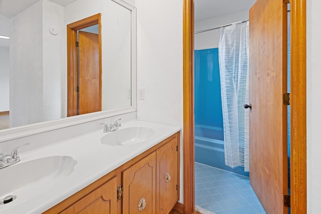 bathroom featuring tile patterned flooring, vanity, and shower / tub combo