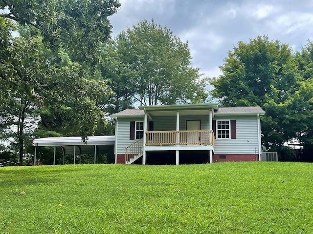 rear view of house featuring covered porch, cooling unit, and a lawn