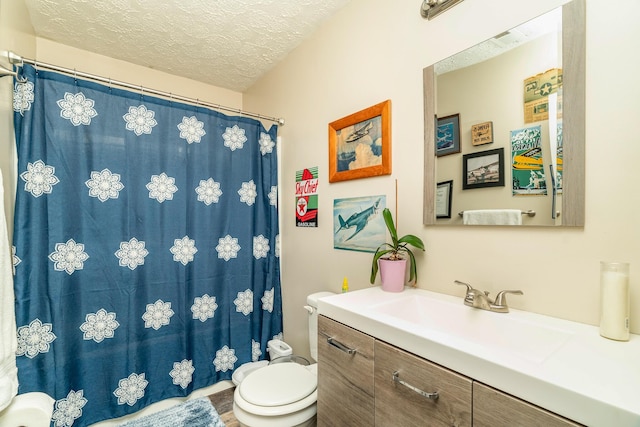 bathroom featuring hardwood / wood-style floors, vanity, a textured ceiling, and toilet