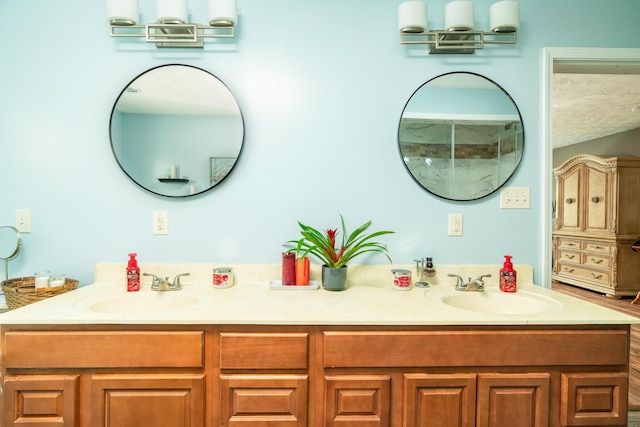 bathroom featuring a textured ceiling and vanity