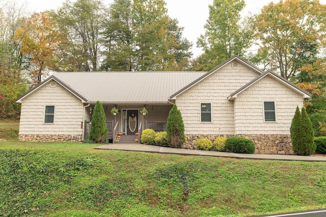 ranch-style home with a porch and a front yard