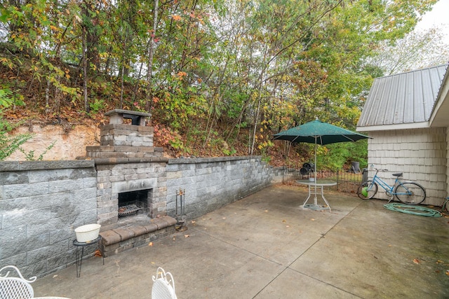 view of patio with an outdoor stone fireplace