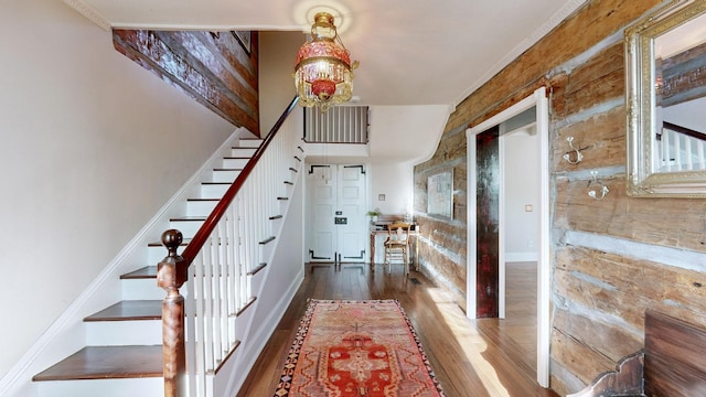 staircase with hardwood / wood-style floors