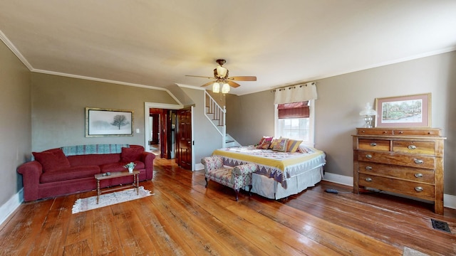 bedroom with ceiling fan, wood-type flooring, and ornamental molding