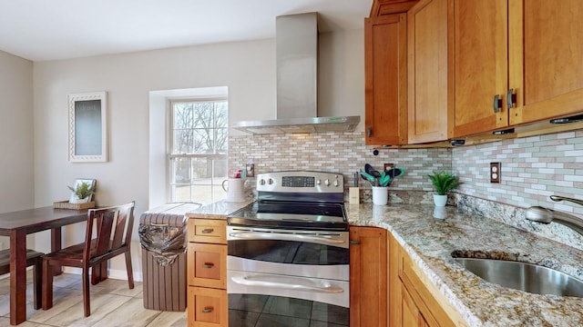 kitchen featuring light stone countertops, sink, wall chimney exhaust hood, backsplash, and stainless steel electric range