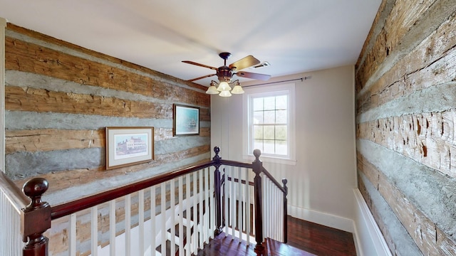 staircase featuring hardwood / wood-style floors and ceiling fan