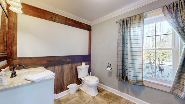 bathroom featuring toilet, vanity, a healthy amount of sunlight, and ornamental molding