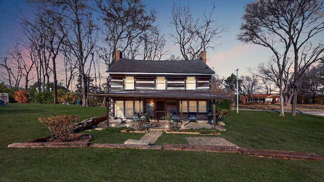 view of front of property with a yard and a patio