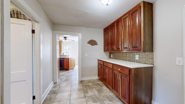 kitchen with tasteful backsplash, ceiling fan, and light tile patterned floors