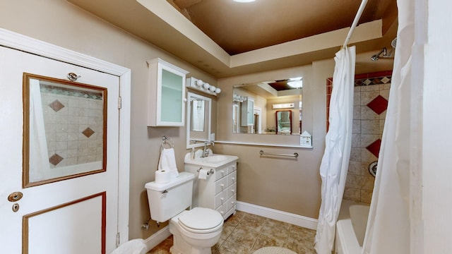 full bathroom with vanity, a tray ceiling, shower / tub combo with curtain, tile patterned flooring, and toilet