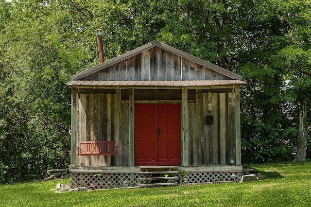 view of outbuilding featuring a lawn