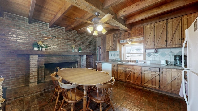 kitchen with brick wall, white appliances, ceiling fan, sink, and beam ceiling