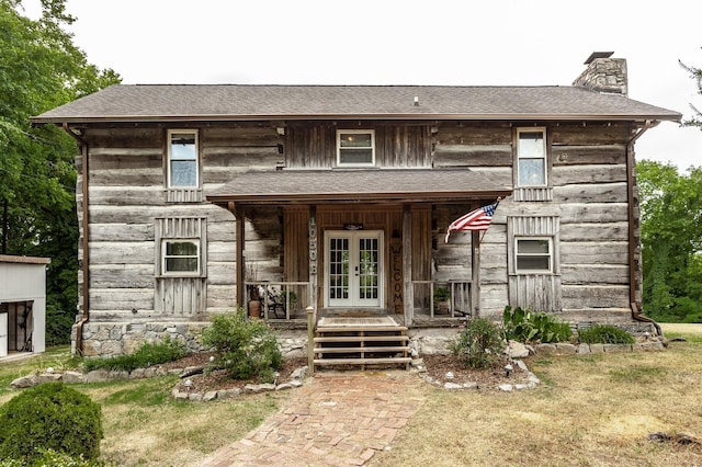 view of front of property with a porch and french doors