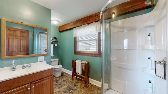 bathroom with vanity, toilet, and a shower with door