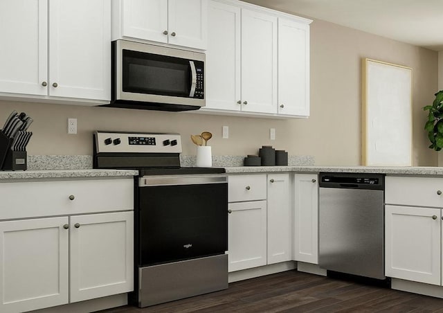 kitchen with white cabinets, appliances with stainless steel finishes, and dark hardwood / wood-style floors