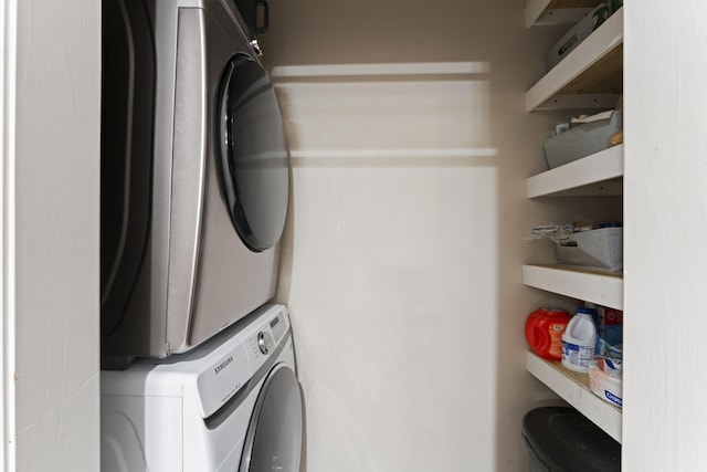 washroom with stacked washing maching and dryer