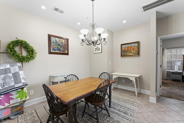 tiled dining area with a chandelier