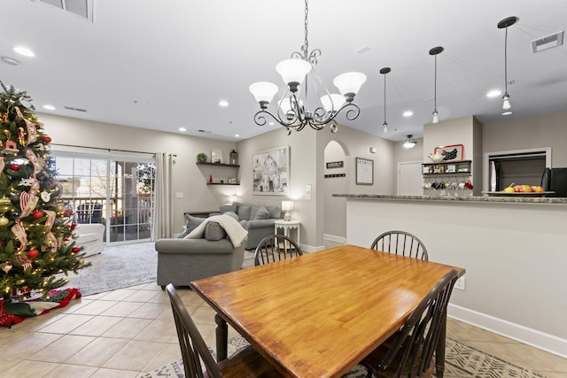 dining room featuring a notable chandelier and light tile patterned flooring