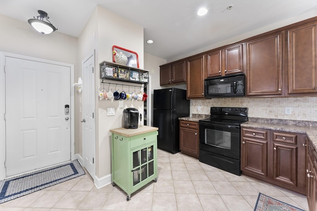 kitchen with dark brown cabinets, tasteful backsplash, and black appliances