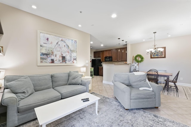 tiled living room with a notable chandelier