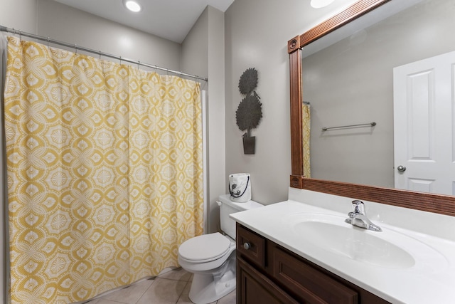 bathroom with tile patterned flooring, vanity, and toilet