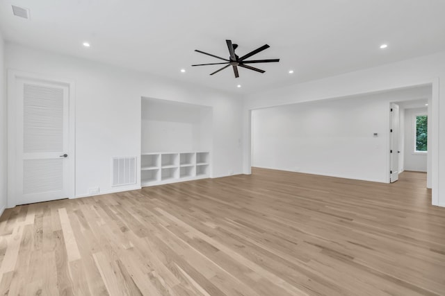 unfurnished living room featuring ceiling fan and light hardwood / wood-style floors