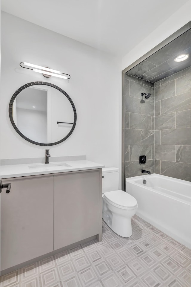 full bathroom with vanity, toilet, and tiled shower / bath