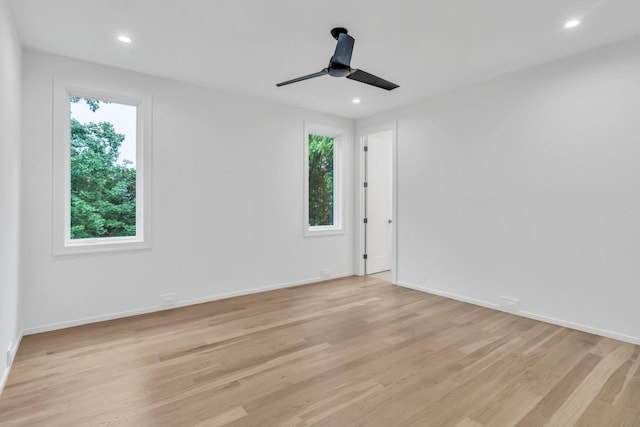 empty room featuring ceiling fan and light hardwood / wood-style flooring