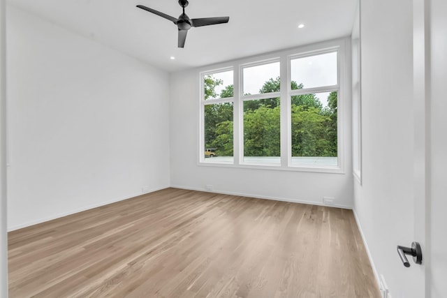 spare room featuring ceiling fan and light wood-type flooring