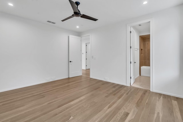 unfurnished bedroom featuring light wood-type flooring, connected bathroom, and ceiling fan