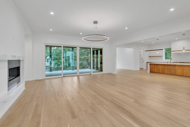 unfurnished living room featuring light wood-type flooring