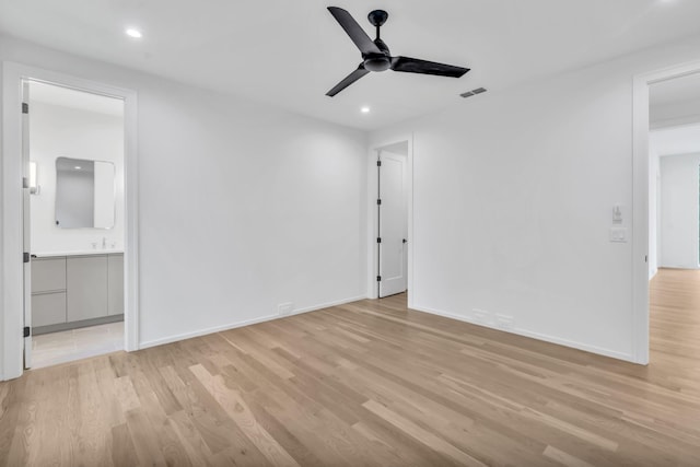 unfurnished room with ceiling fan, light hardwood / wood-style flooring, and sink