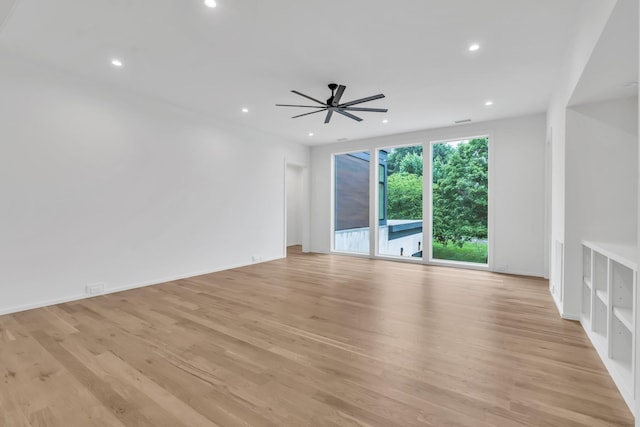 spare room with ceiling fan and light hardwood / wood-style floors