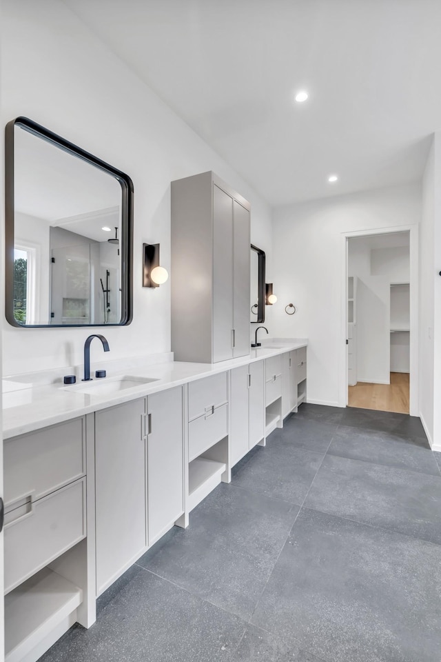 bathroom featuring a shower and vanity